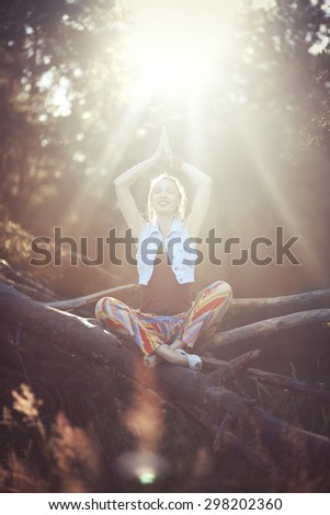 Meditating woman in the sunset light.