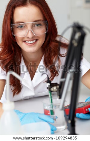 Young female lab technician works on some samples, lab shoot