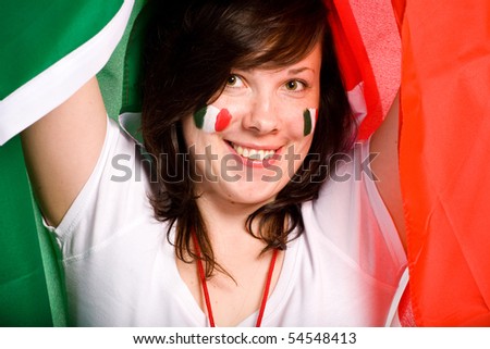 young happy female with italian flag as background, also italian flags on her cheeks
