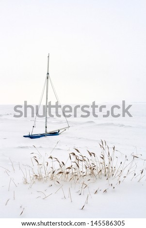 lonely isolated Sailing Boat at german Baltic Sea Coast in Winter
