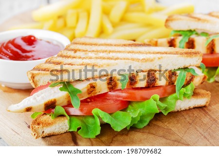 Sandwich with grilled chicken and tomatoes  french fries