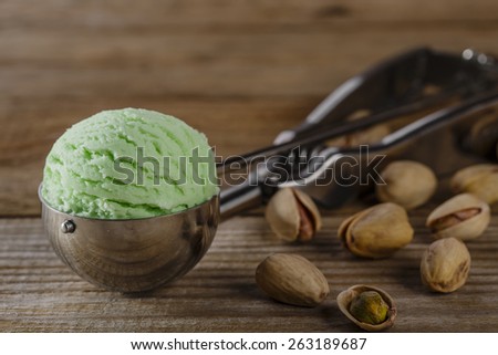 pistachio ice cream ball in a spoon scoop