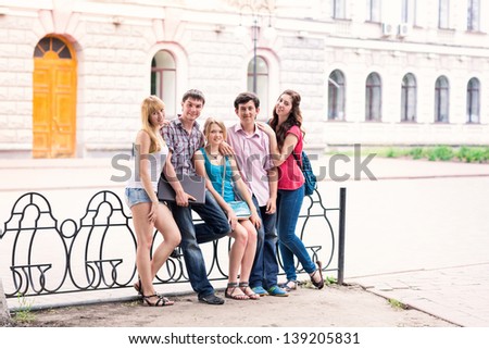 Group of happy smiling Teenage Students Outside College talking