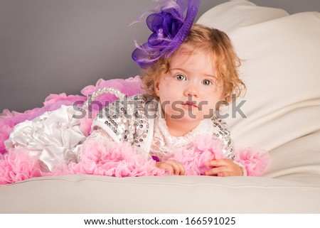 Cute little baby in a dress with a purse, little lady