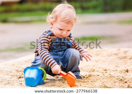 Similar – Image, Stock Photo Baby playing alone with toys on a carpet on the floor at home