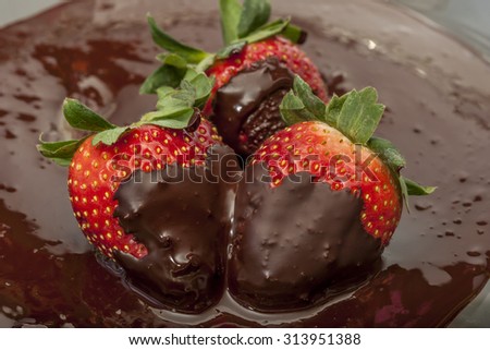 Chocolate covered strawberries in pool of Chocolate sauce