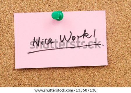 Nice work words written on paper and pinned on cork board