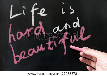 Life is hard and beautiful words written on the blackboard using chalk