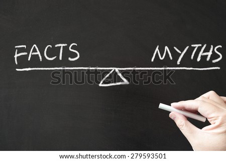 Facts vs Myths words written on the blackboard using chalk