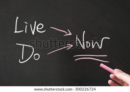 Live now and do now words written on blackboard using chalk