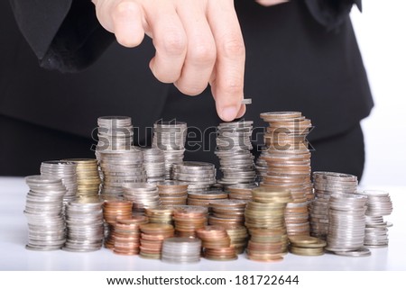 Business women put coin stack money for money growth concept