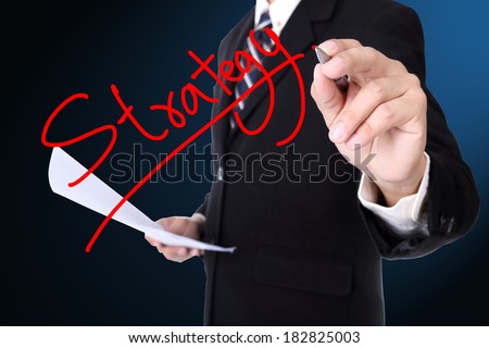 Businessman writing Strategy  for show case to team