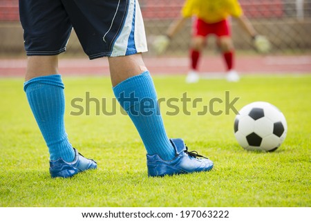 Soccer player preparing free kick in the stadium.