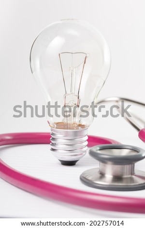 Stethoscope and idea lamp on daily book