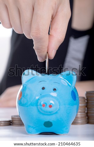 Piggy bank officer put money inside for invest in the future