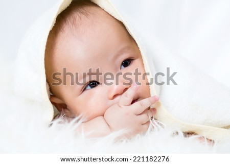 Little baby kid sleep and smile to camera in studio