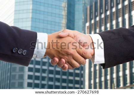 Businessman shake hands for deal thier business.