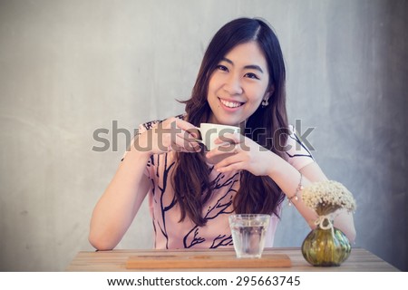 Young Asian girl drink coffee in coffee shop