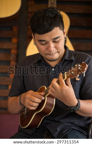 Ukulele Guitar teacher teach music in school