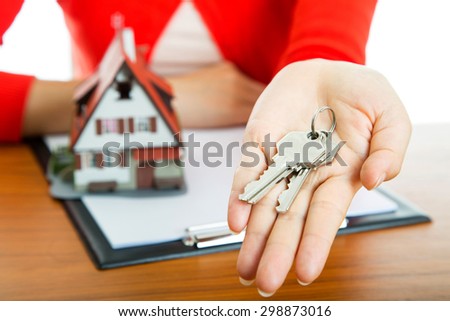 Woman show Keys for your good property with real agency property.