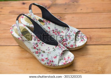 Woman shoes fashion on wood table in the garden.