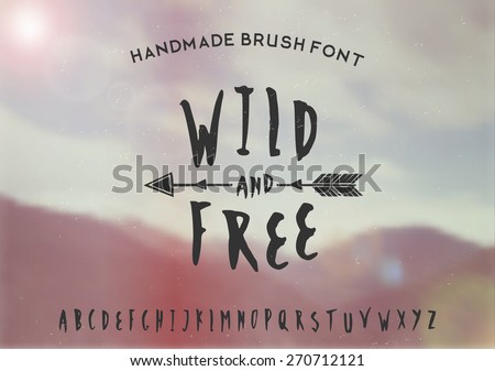 Hand drawn brush font on a blurred vintage style mountain view background. EPS 10 file, gradient mesh and transparency effects used.