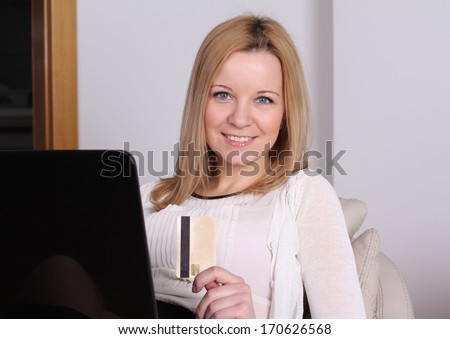 Young women with laptop and credit card. Online shopping concept