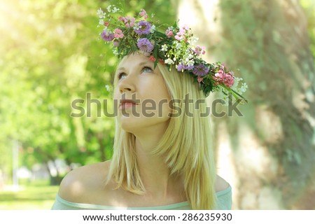 Young beautiful women with flower wreath, enjoying outside