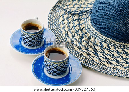 Summer coffee break , female straw hat and two cups of turkish coffee