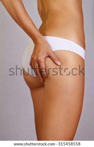 Checking cellulite, woman hip, buttocks.  Close up of fit, shape, beautiful female body, legs belly