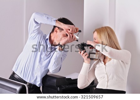 Male and female office colleagues having fun. Office fun concept. Business man and woman at work