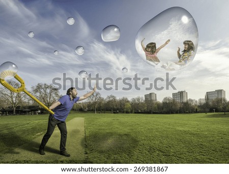 Man making bubbles with his children in a park in a sunny day