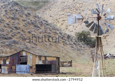 Shot of a Windmill ans an old shed located in California\'s central valley.