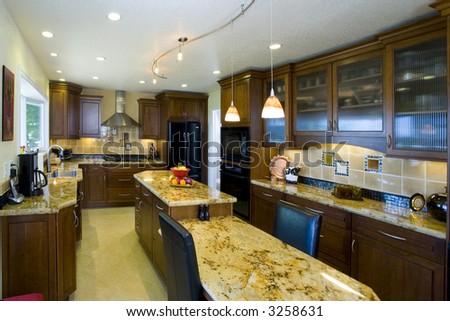 Shot of a recently remodeled kitchen featuring natural materials, cherry cabinets and beautiful granite.