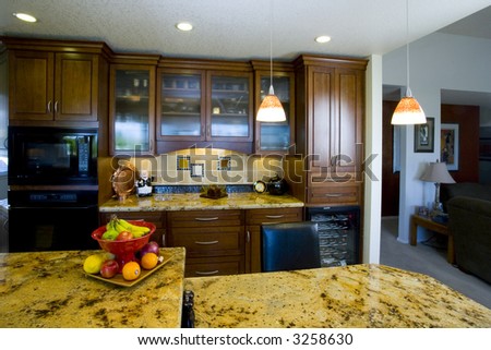 Shot of a recently remodeled kitchen featuring natural materials, cherry cabinets and beautiful granite.