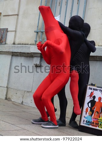 AVIGNON, FRANCE - JULY 18: Unidentified actors perform in the street, to advertise their theater show, during the annual Avignon Theater Festival in Avignon, France on July 18, 2011.