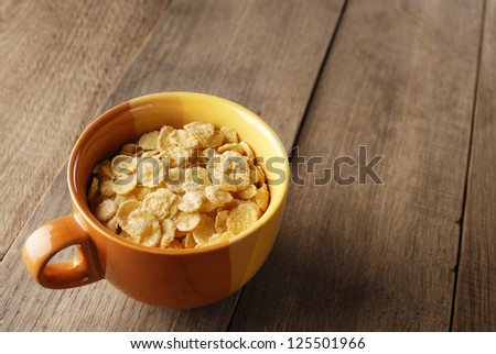 Bowl of cereals on the wooden table closeup