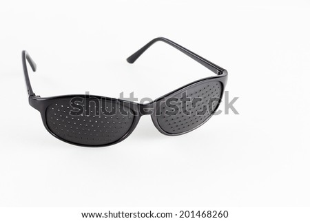 Pinhole eyeglasses help relaxing weary eyes, on white background.