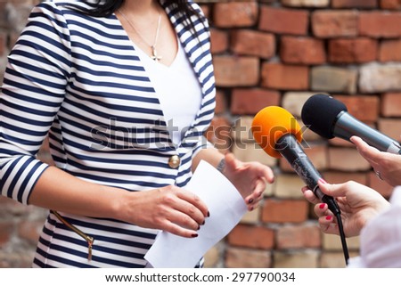 Journalists making interview with woman