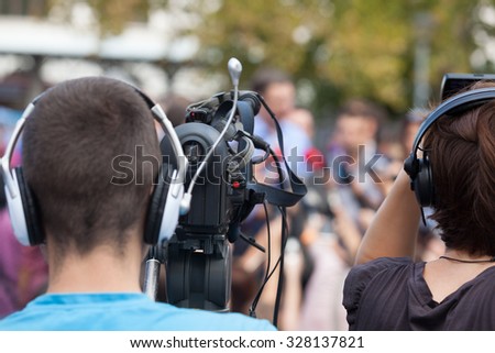 News conference. Cameraman. Video camera.
