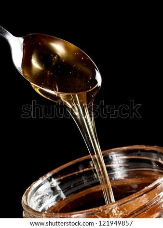 Honey flow from a spoon