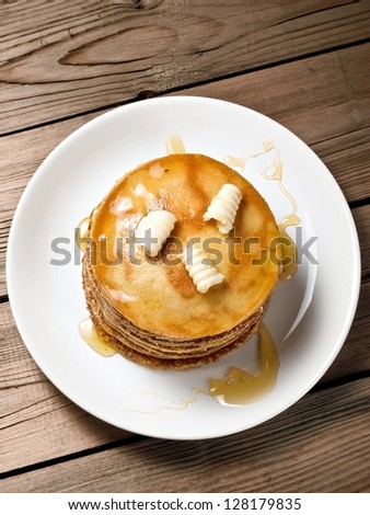 Small pancakes with honey and butter, top view