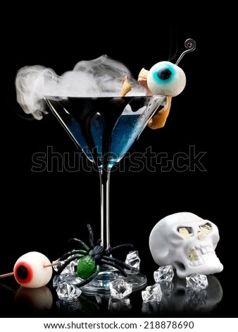 Blue Halloween cocktail with eyes, smoke and skull