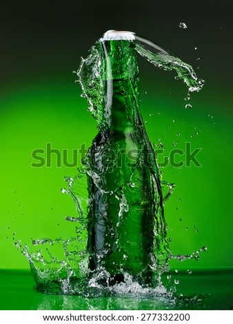 Green beer bottle splash