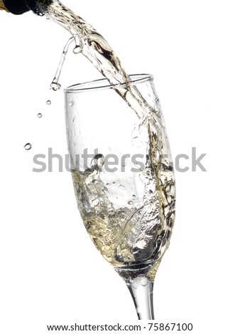 Champagne pouring into a glass with drops