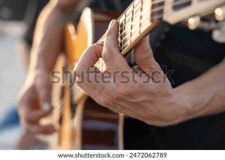 Similar – Image, Stock Photo Guitarist playing outdoors