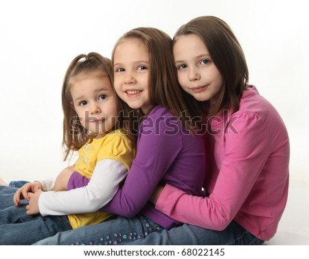 Three Cute Young Sisters Hugging Each Other, Isolated On White Stock ...