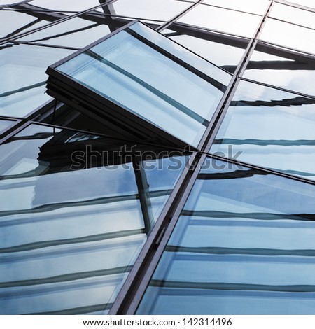 detail picture of a glass facade with open windows