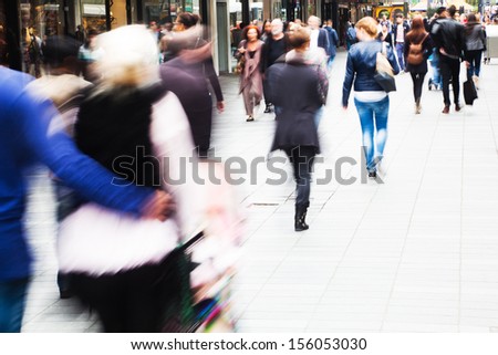 crowds of shopping people walking in the city