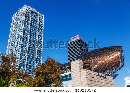 BARCELONA, SPAIN - OCTOBER 13: at the Port Olympic on October 13, 2013 in Barcelona. The left is the luxury hotel Arts, the right is the Mapfre tower and between the whale sculpture of Frank Gehry.